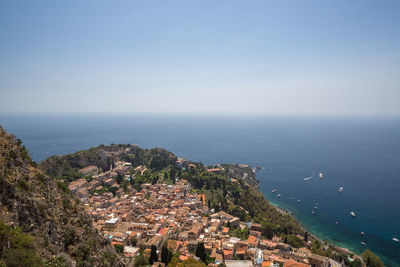 High angle view of townscape by sea against sky