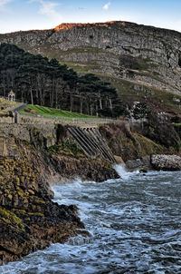 Scenic view of waterfall against sky