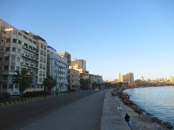 Street amidst buildings against clear sky