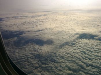 Aerial view of cloudscape seen from airplane window