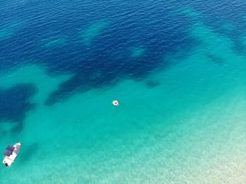 High angle view of people swimming in sea