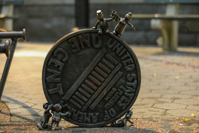 Close-up of old wheel on footpath