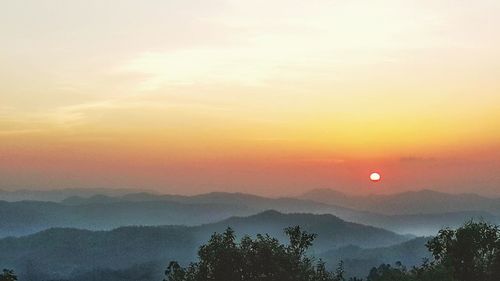 Scenic view of silhouette mountains against sky during sunset