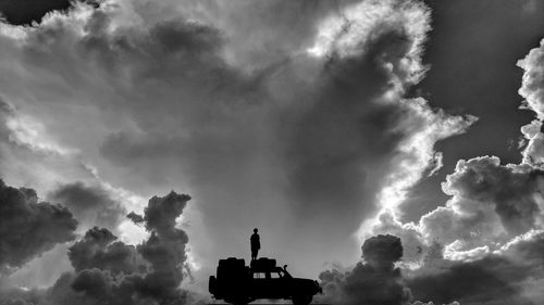 Low angle view of silhouette statue against sky