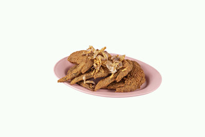 High angle view of bread in plate against white background