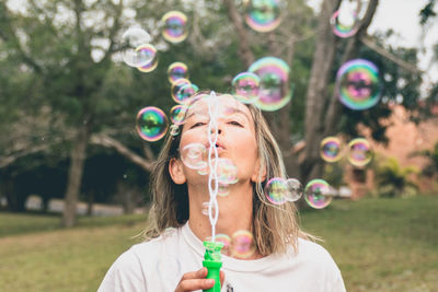 Portrait of girl holding bubbles