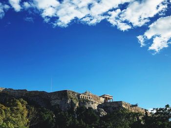 Low angle view of buildings against blue sky