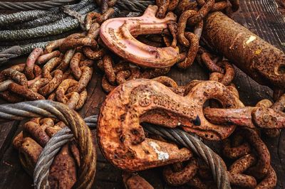 High angle view of rusty hooks and chains