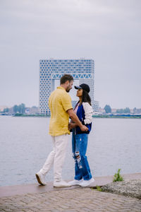 Couple standing by sea