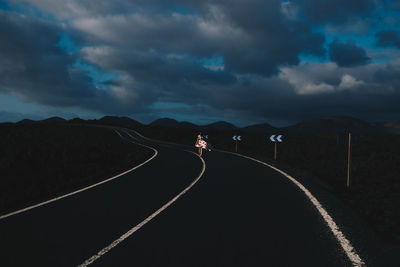 Empty road against sky during sunset