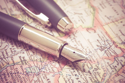 Close-up of fountain pen on map