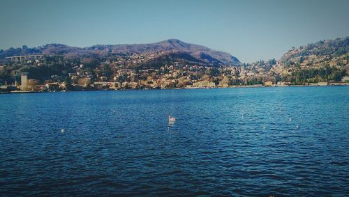 View of calm sea with city in background