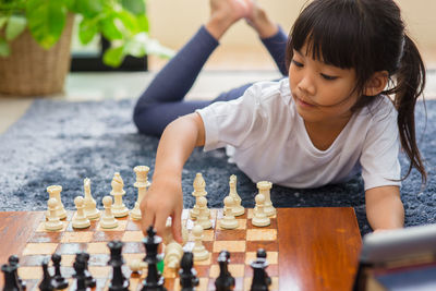 Full length of children playing on chess board