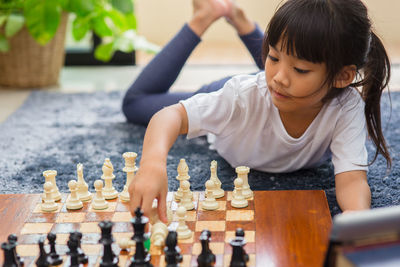 Girl playing chess at home
