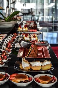 Desserts with fruits in bowl arranged on table