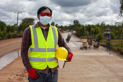 Rear view of man wearing hat standing on street