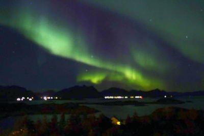 Scenic view of illuminated mountains against sky at night