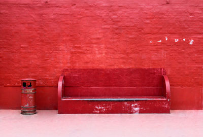 Seat against red brick wall