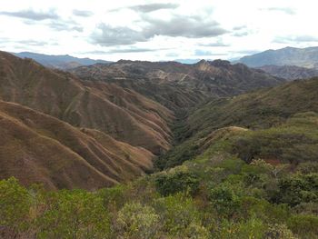 Scenic view of mountains against cloudy sky