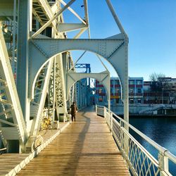 Footbridge over footpath against clear sky