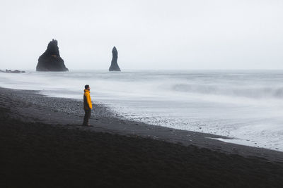 Rear view of woman looking at sea against sky