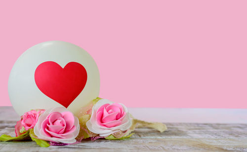 Close-up of pink rose on table