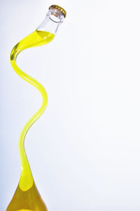 Close-up of yellow object over white background