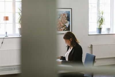 Mature woman sitting at desk