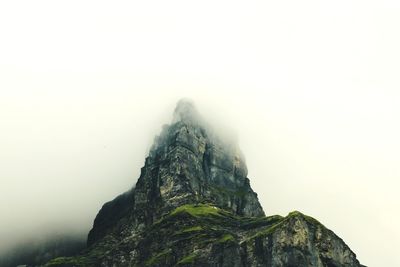 Low angle view of rock formation against sky