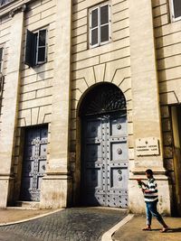 Full length rear view of man walking in city