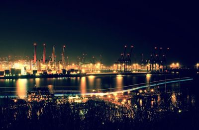 Illuminated port of hamburg at night