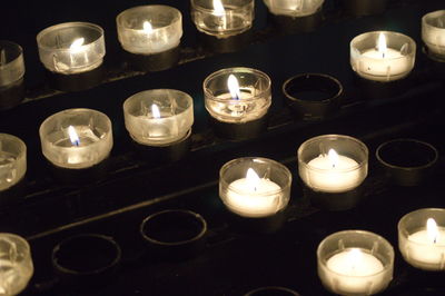 High angle view of illuminated tea light candles