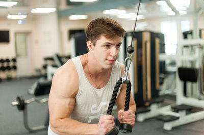 Young man exercising in gym