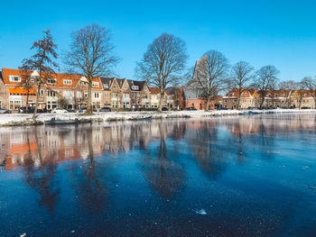 Reflection of trees and buildings in lake