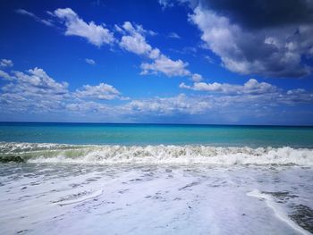 Scenic view of sea against blue sky