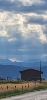 Scenic view of hut against mountains and sky