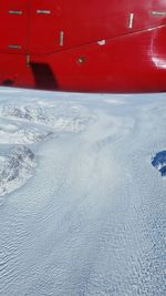 Aerial view of red car against sky during winter