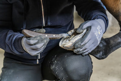 Midsection of man holding seashell