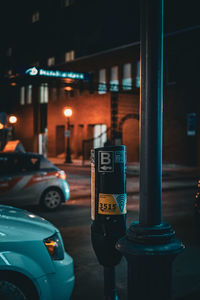 Rear view of man standing on street at night