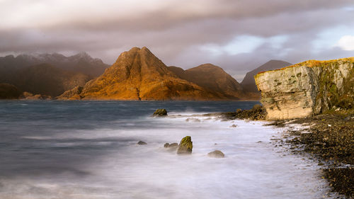 Scenic view of mountains against cloudy sky