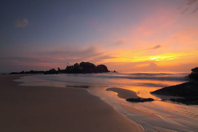 Scenic view of beach against sky during sunset