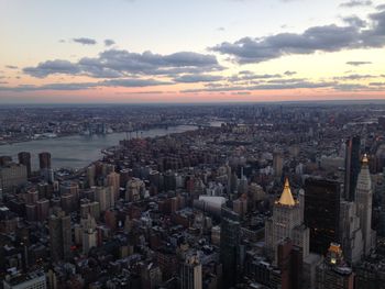 Aerial view of cityscape against sky during sunset