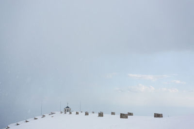 High section of snow covered landscape against sky