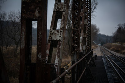Abandoned railroad tracks against sky
