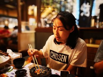 Woman holding ice cream in restaurant