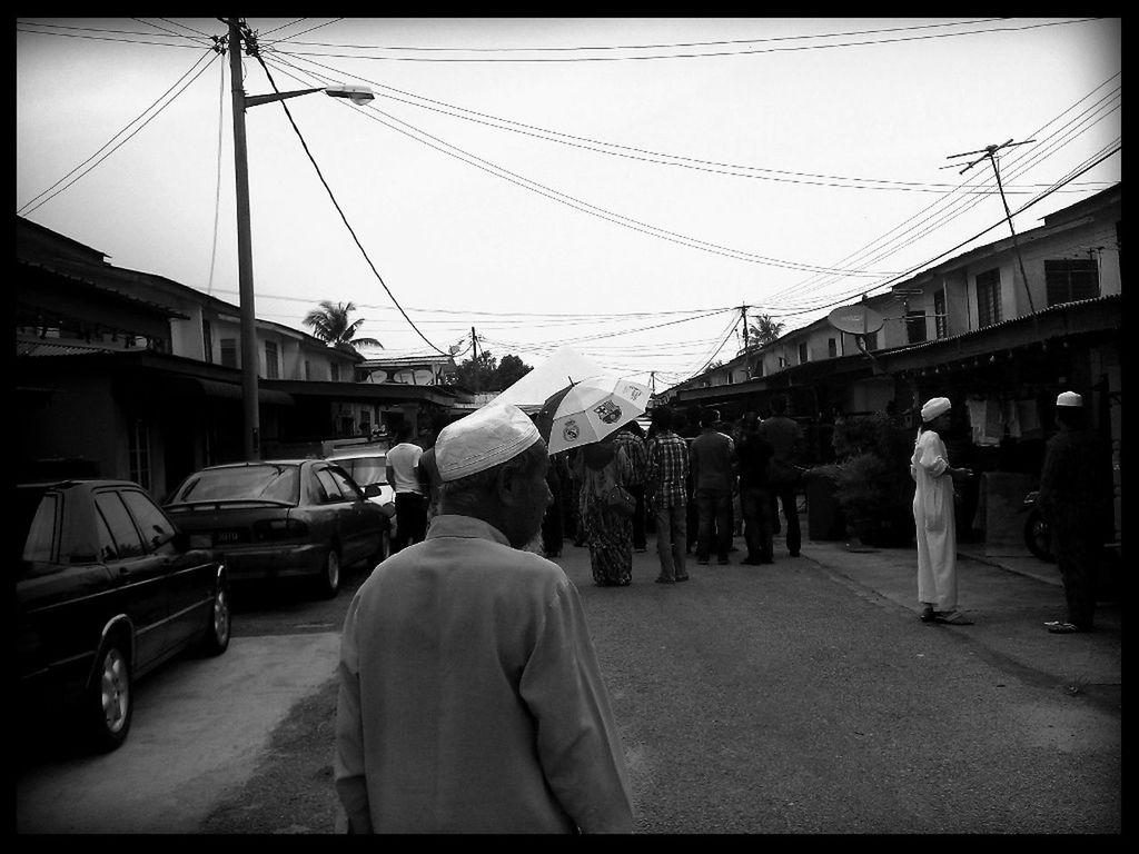 transportation, mode of transport, men, architecture, building exterior, built structure, transfer print, lifestyles, city, street, city life, person, rear view, land vehicle, auto post production filter, car, incidental people, public transportation