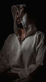 Digital composite image of man against black background