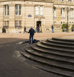 People on sidewalk in city