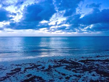 Scenic view of sea against blue sky