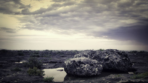 Rock formations on landscape against sky